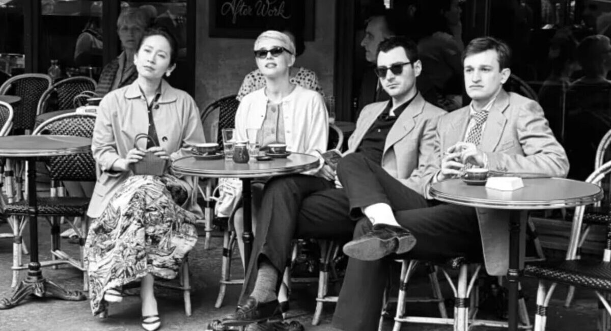 People sitting at Paris cafe tables shot in black and white